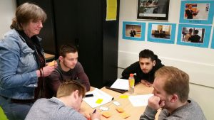 In een groep deelnemers aan de workshop pesten en pestpreventie wordt informatie uitgewisseld 